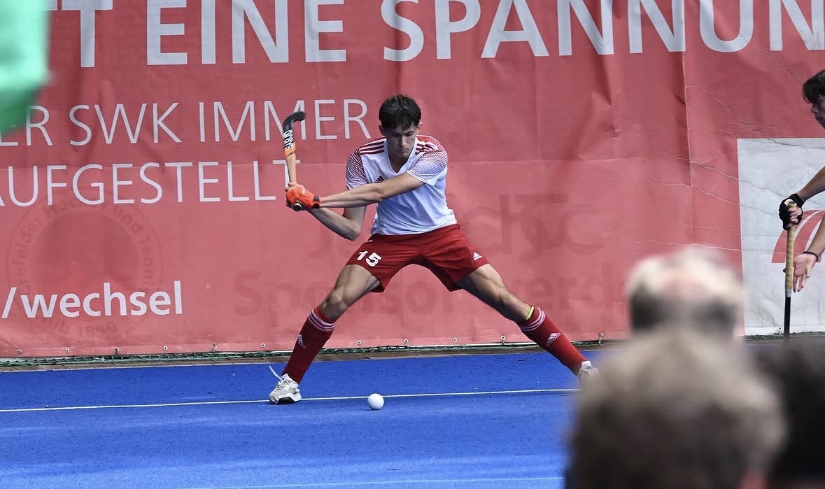 Jack Webb striking a ball for his national hockey team